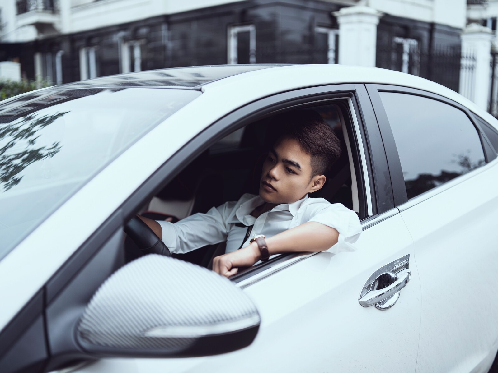 A calm, confident driver at the wheel in daylight